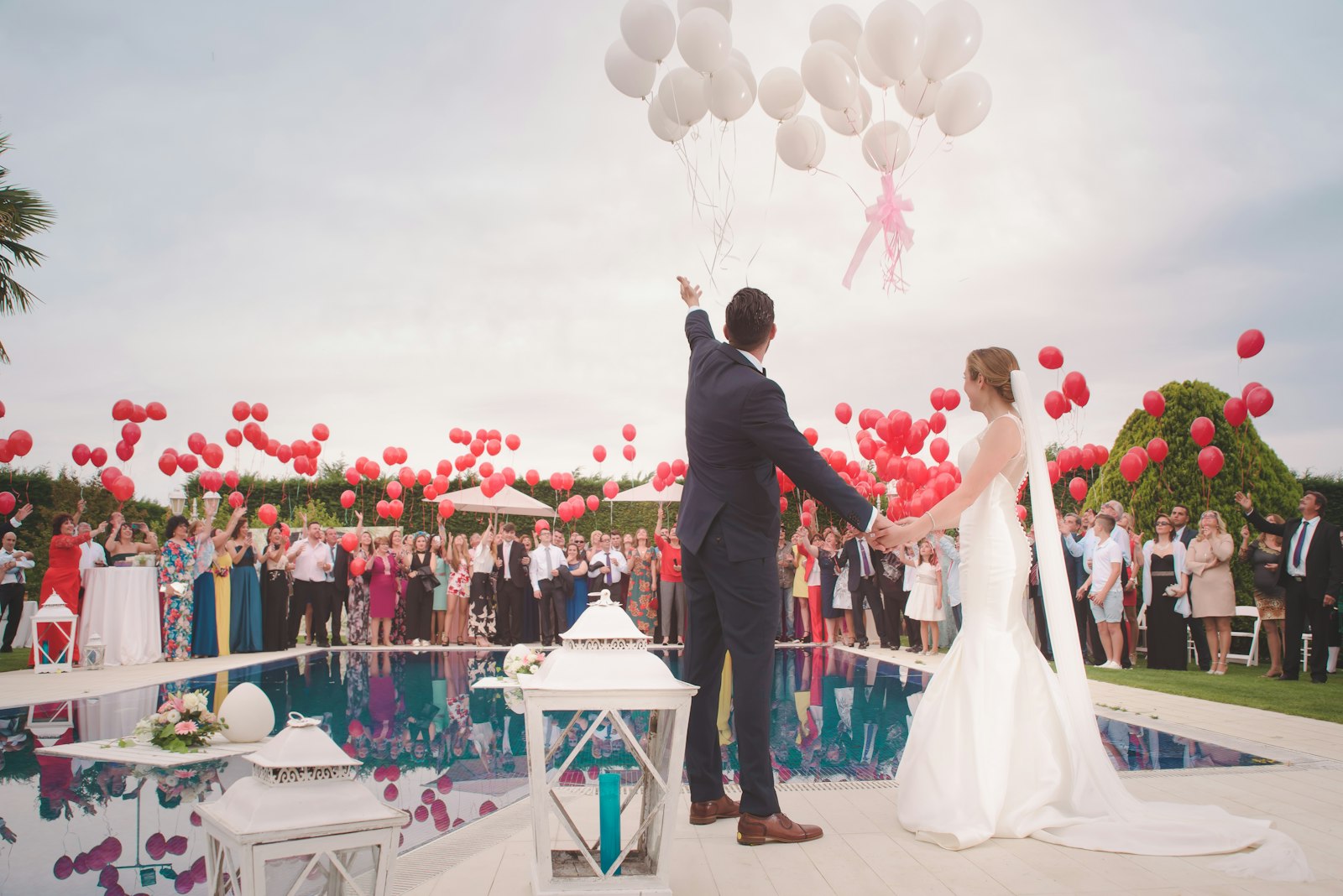 Releasing balloons by the pool with friends and family
